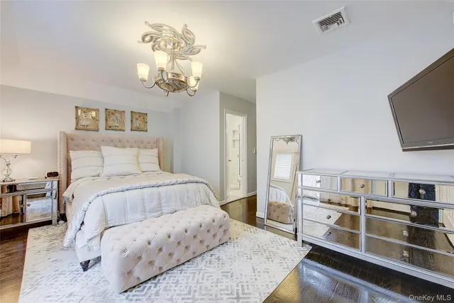 a bedroom with a bed and a television