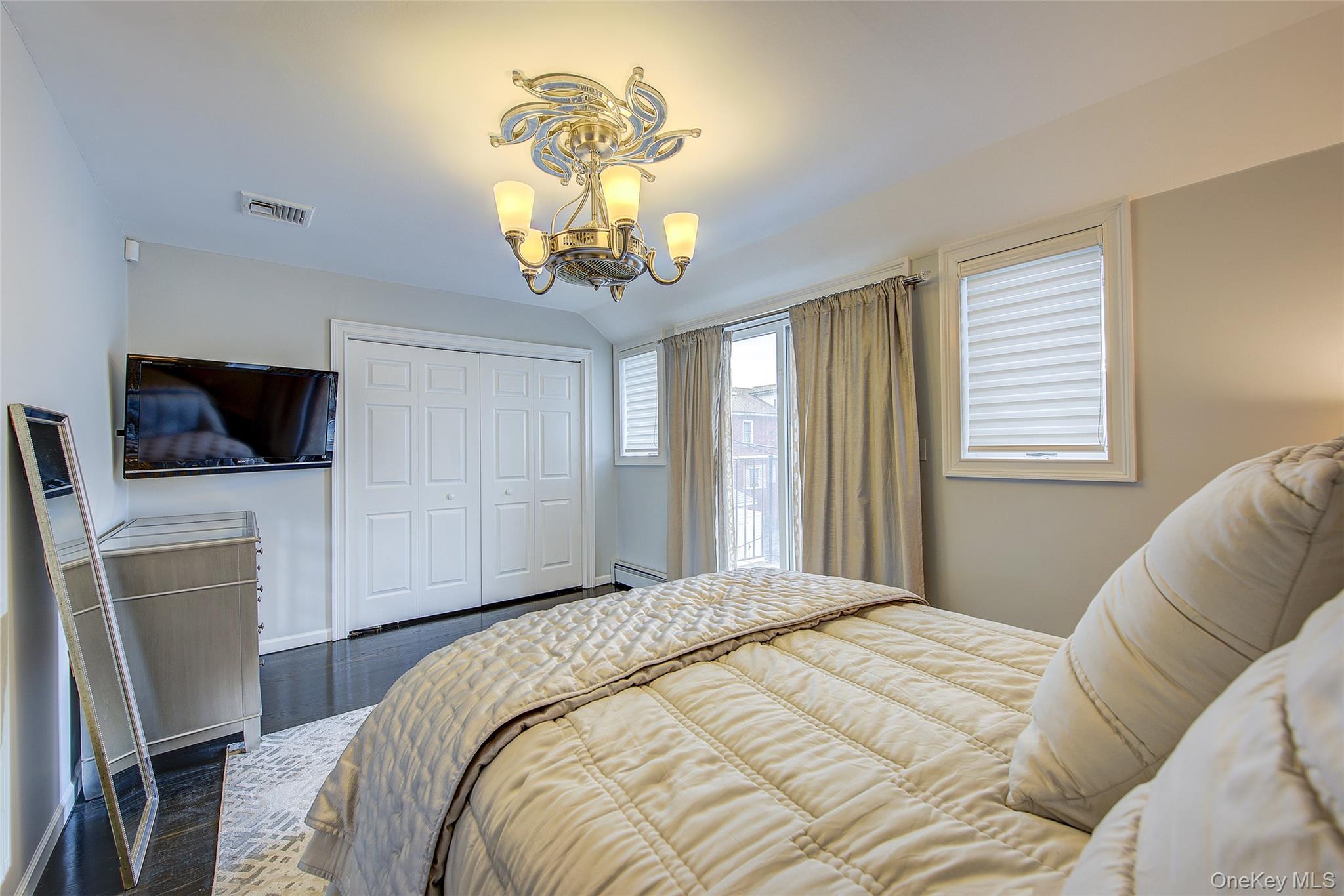 161 Beach 128th Street, Unit 1B Queens, NY 11694 - Photo 25 of 36 a bedroom with a bed and a television