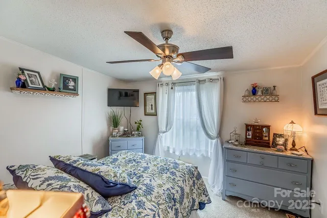 a bedroom with bed and a chandelier