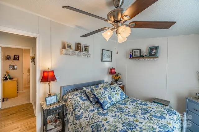 a bedroom with a bed and wooden floor