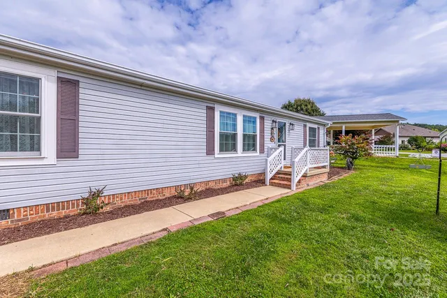 a front view of a house with a yard and trees