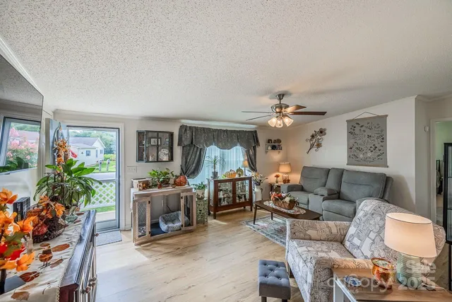a living room with furniture and a chandelier