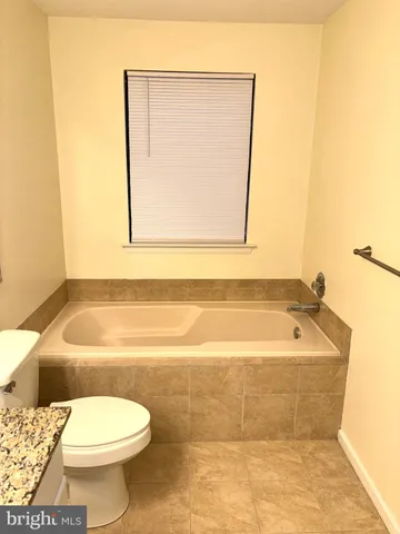 a bathroom with a toilet a sink and bathtub