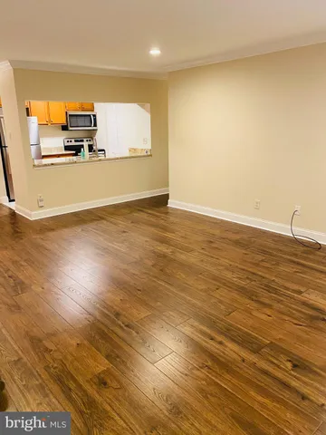a view of a room with wooden floor