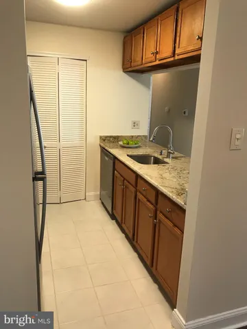 a kitchen with a sink cabinets and a window
