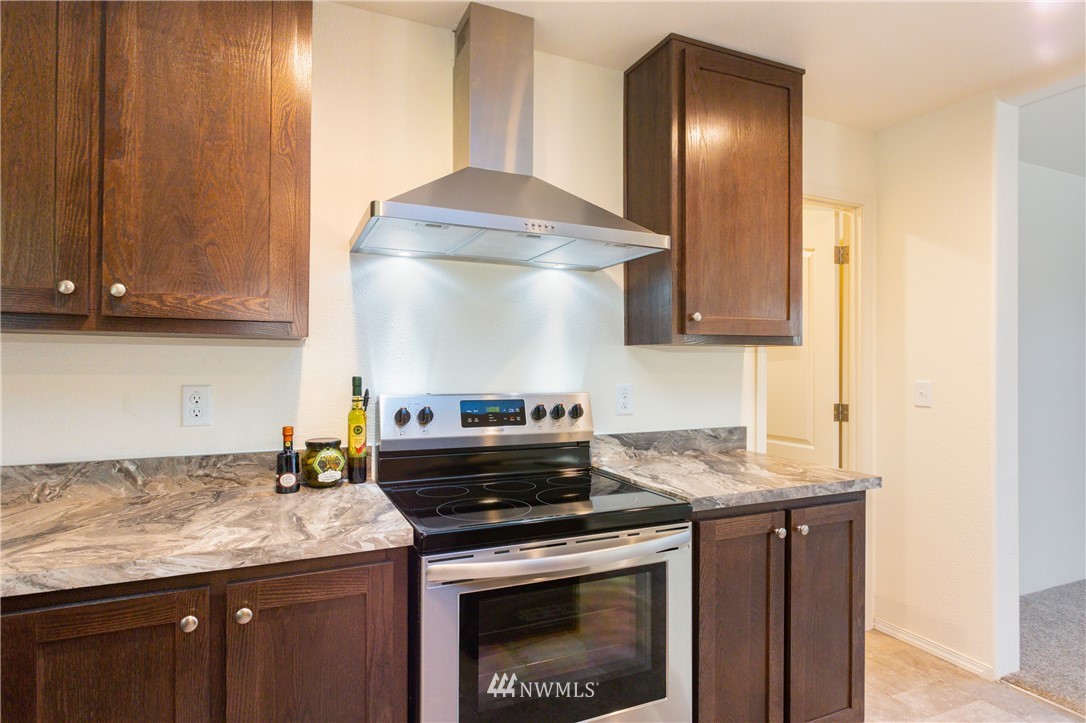 3116 Creasey Road Custer, WA 98240 - Photo 11 of 28 a kitchen with granite countertop a stove and a cabinets
