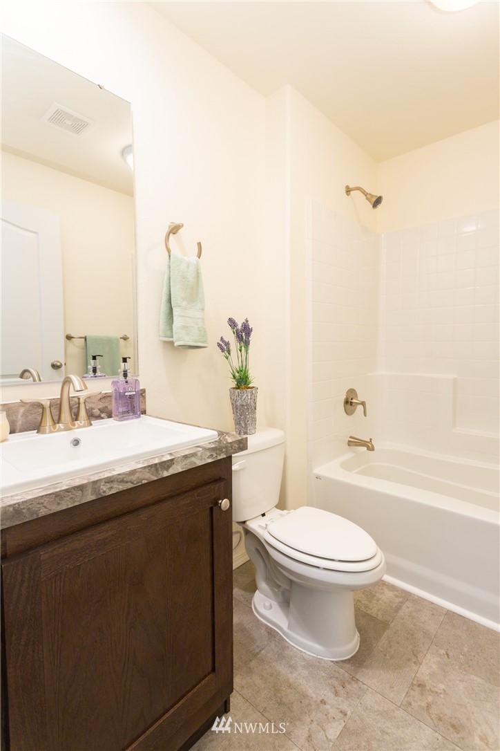 3116 Creasey Road Custer, WA 98240 - Photo 21 of 28 a bathroom with a granite countertop bathtub sink mirror vanity and toilet