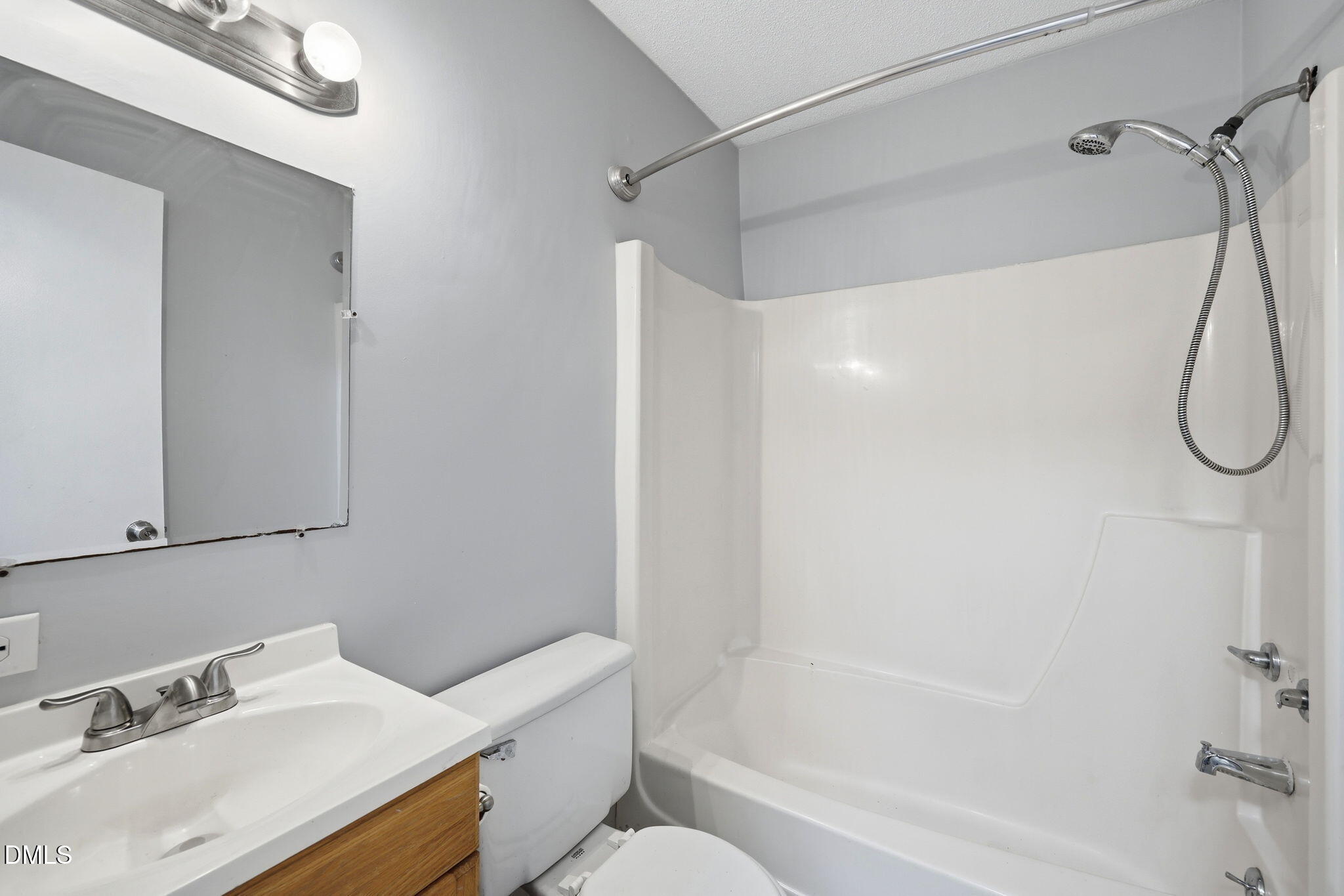 5043 Tall Pines Court Raleigh, NC 27609 - Photo 21 of 37 a bathroom with a sink and a mirror