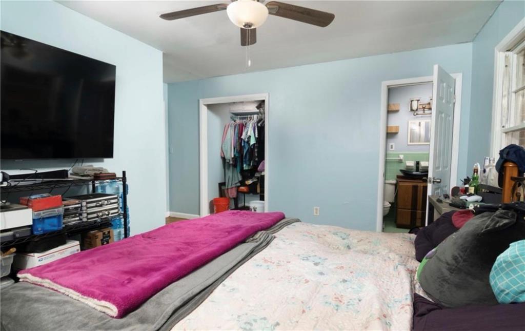 98 Almon Church Road Covington, GA 30014 - Photo 20 of 22 a bedroom with a bed and a flat screen tv