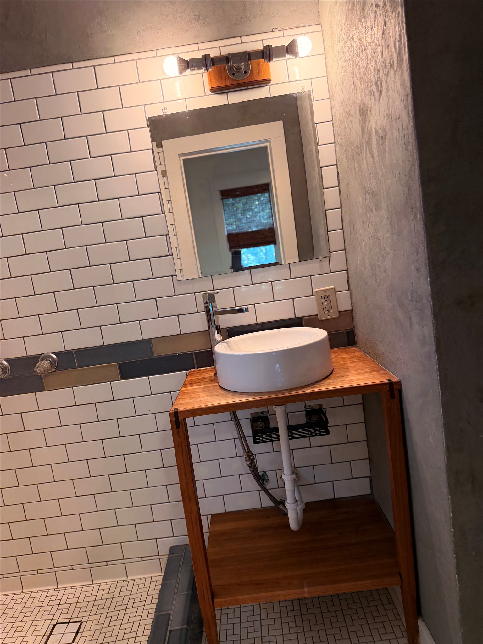 1136 Eleanor Street Austin, TX 78721 - Photo 17 of 30 A stylish, tiled bathroom features a modern vessel sink set atop a sleek wooden vanity.