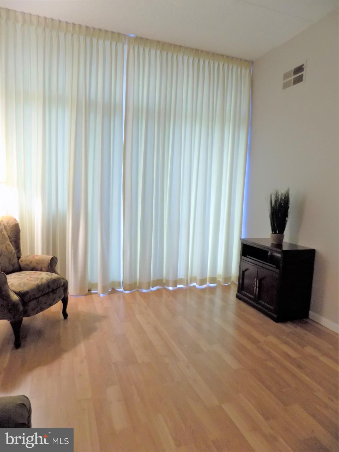 11564 Rolling Green Court, Unit 101 Reston, VA 20191 - Photo 11 of 71 Family room with elegant floor to ceiling drapes