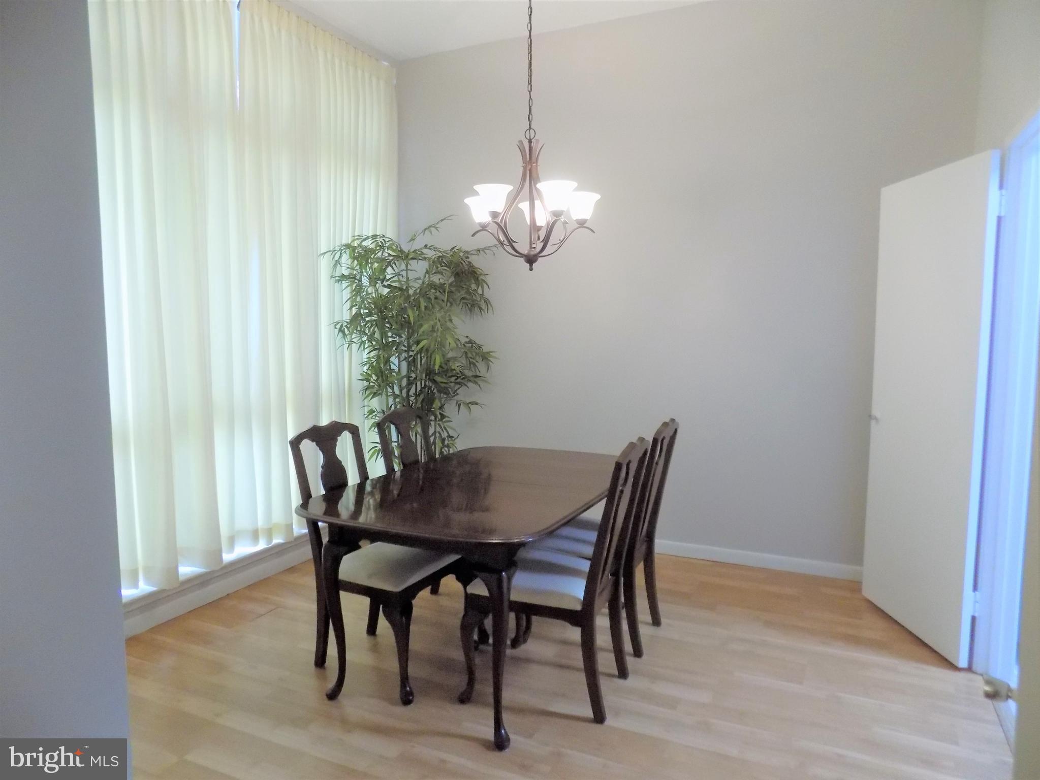 11564 Rolling Green Court, Unit 101 Reston, VA 20191 - Photo 14 of 71 Formal dining room with floor to ceiling windows