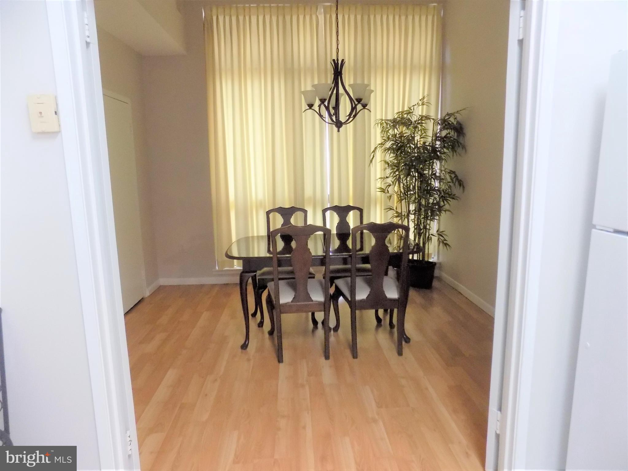 11564 Rolling Green Court, Unit 101 Reston, VA 20191 - Photo 16 of 71 Formal dining room with floor to ceiling windows