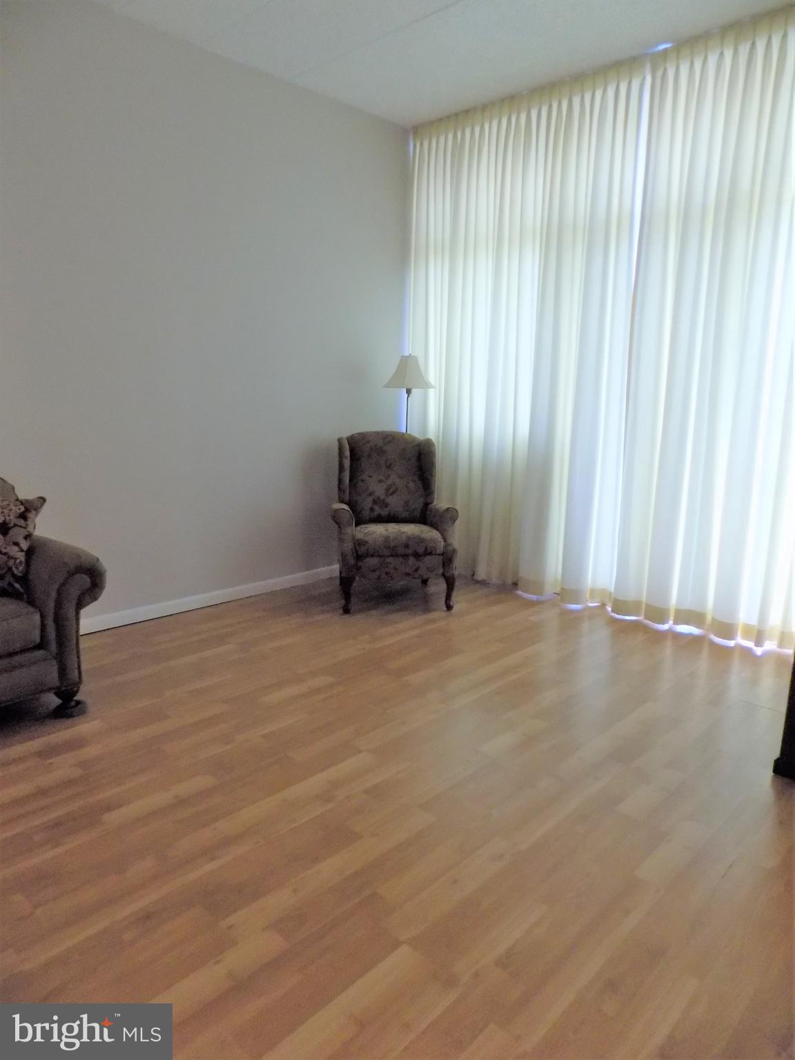 11564 Rolling Green Court, Unit 101 Reston, VA 20191 - Photo 9 of 71 Family room with floor to ceiling windows