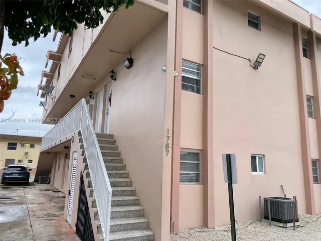 a view of a livingroom with stairs and furniture