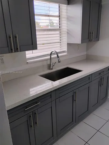 a kitchen with a sink and cabinets