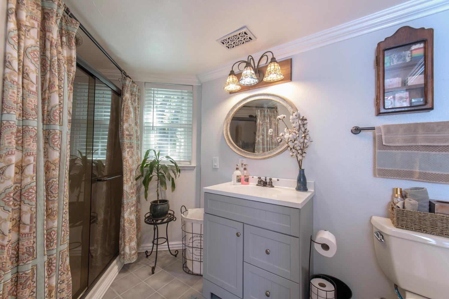 33952 Tocaloma Road Auberry, CA 93602 - Photo 24 of 48 a bathroom with a toilet sink and mirror