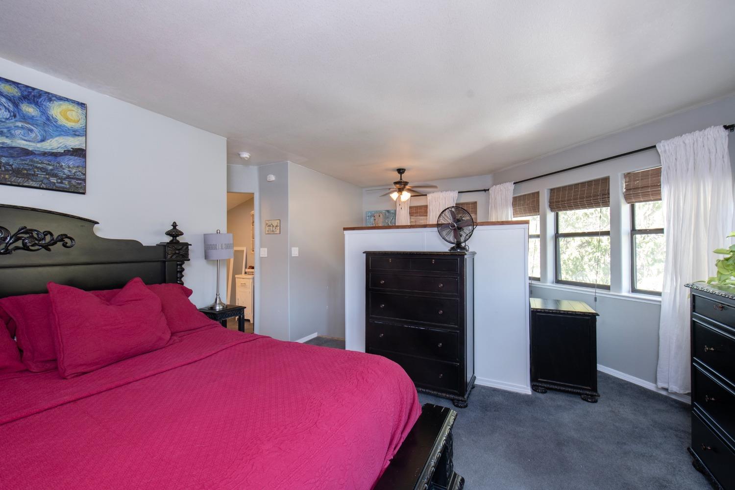33952 Tocaloma Road Auberry, CA 93602 - Photo 26 of 48 a bedroom with a bed and dresser with mirror