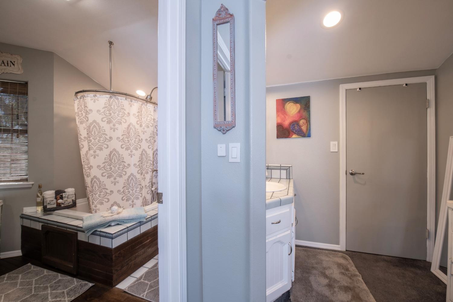 33952 Tocaloma Road Auberry, CA 93602 - Photo 27 of 48 a view of bathroom with a bath tub and shower