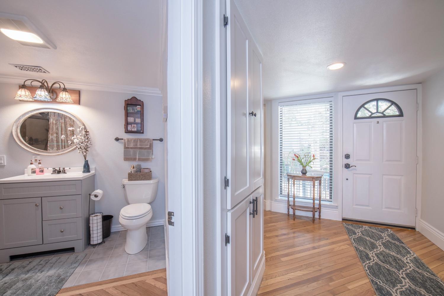33952 Tocaloma Road Auberry, CA 93602 - Photo 33 of 48 a view of bathroom with a toilet a sink and a mirror