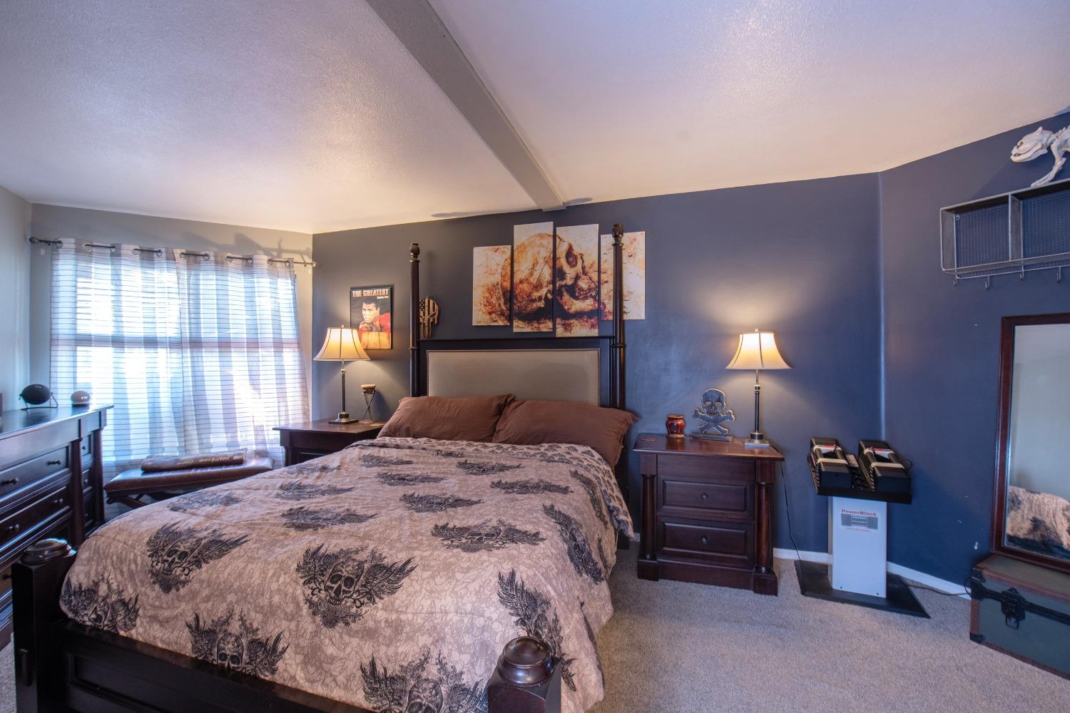 33952 Tocaloma Road Auberry, CA 93602 - Photo 37 of 48 a bedroom with a bed and dresser with mirror