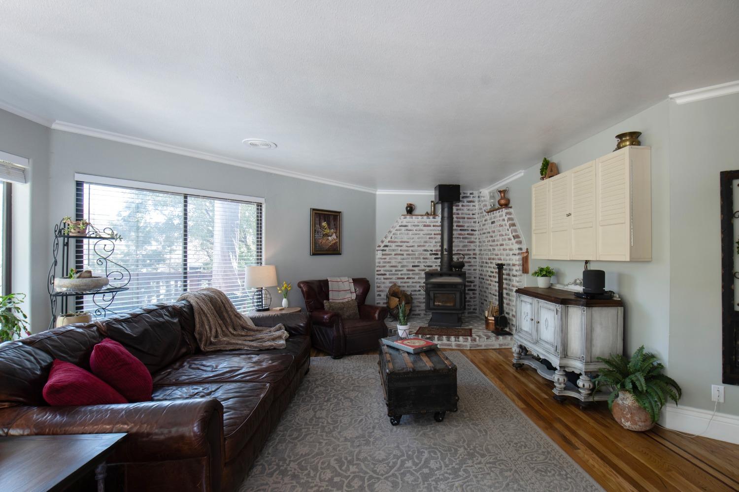 33952 Tocaloma Road Auberry, CA 93602 - Photo 8 of 48 a living room with furniture fireplace and a large window