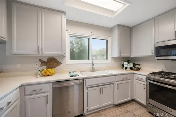 a kitchen with a sink stove and cabinets
