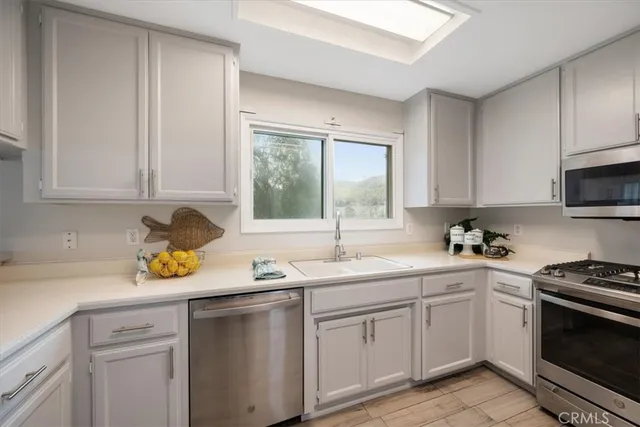 a kitchen with a sink stove and cabinets