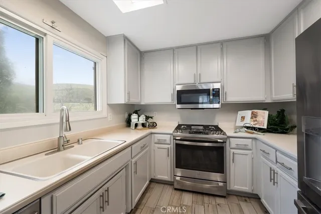 a kitchen with a sink stove top oven and cabinets