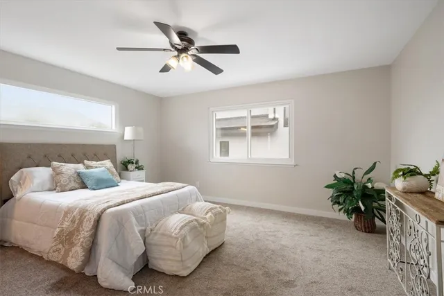 a bedroom with a bed and a potted plant