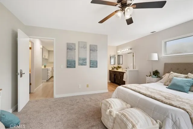 a bedroom with a bed and glass walk in closet