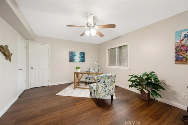 a living room with furniture and a potted plant