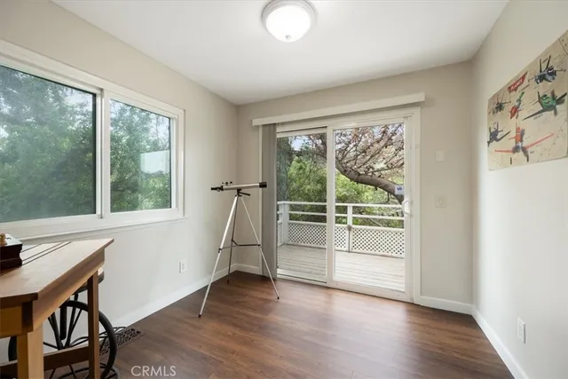 a view of a room with wooden floor and a window