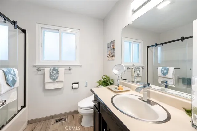 a bathroom with a sink toilet and mirror