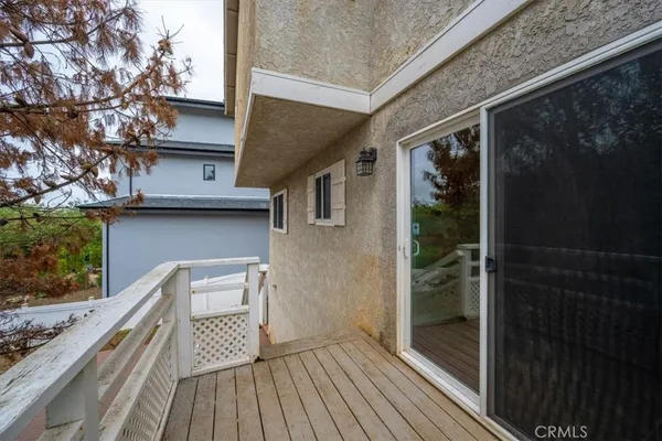 a view of balcony with wooden floor and fence