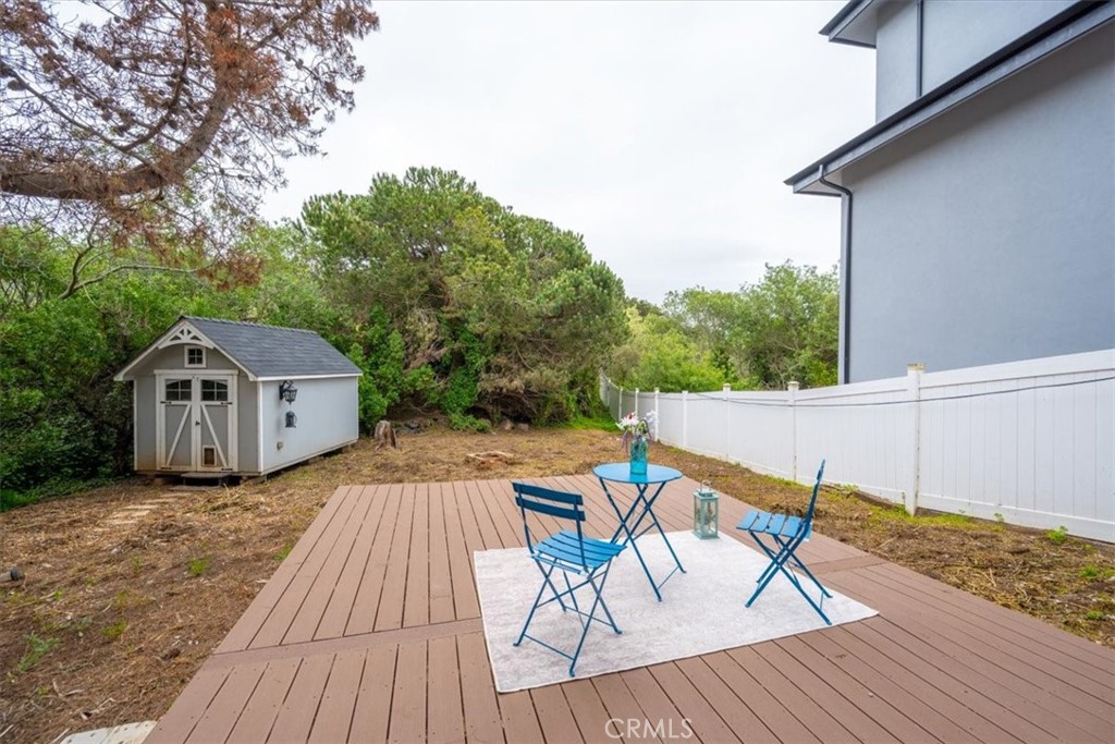 96 24th Street Cayucos, CA 93430 - Photo 32 of 49 a view of a roof deck with table and chairs a barbeque with wooden floor and fence