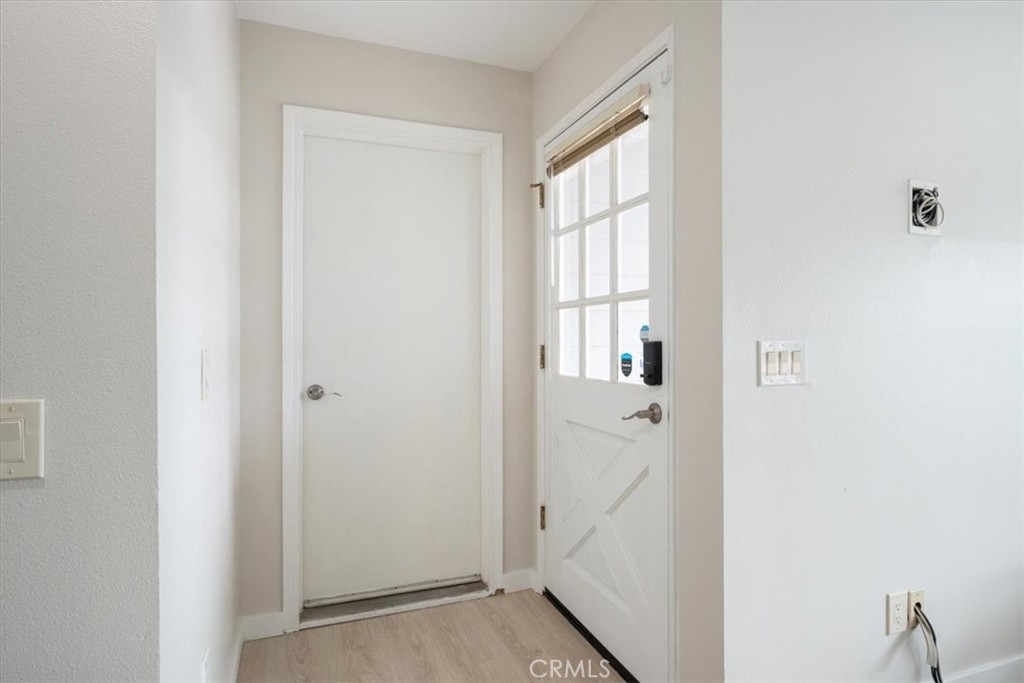 96 24th Street Cayucos, CA 93430 - Photo 6 of 49 a view of a hallway with wooden floor and entryway