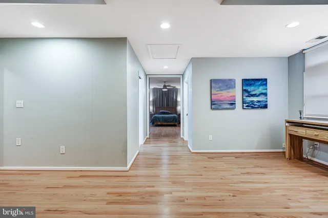 a living room with a bed furniture and a large window
