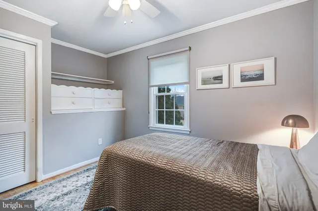 a view of an empty room with wooden floor and stairs