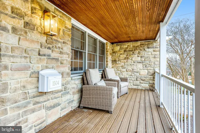 a dining room with wooden floor and a chandelier
