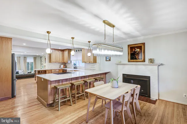 a kitchen with a table chairs and wooden floor