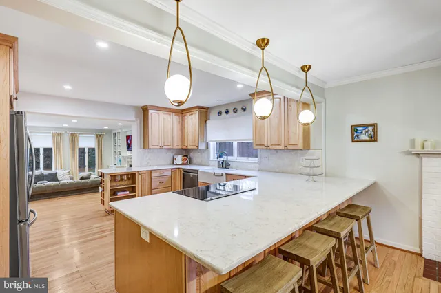 a kitchen with stainless steel appliances a refrigerator and wooden floor