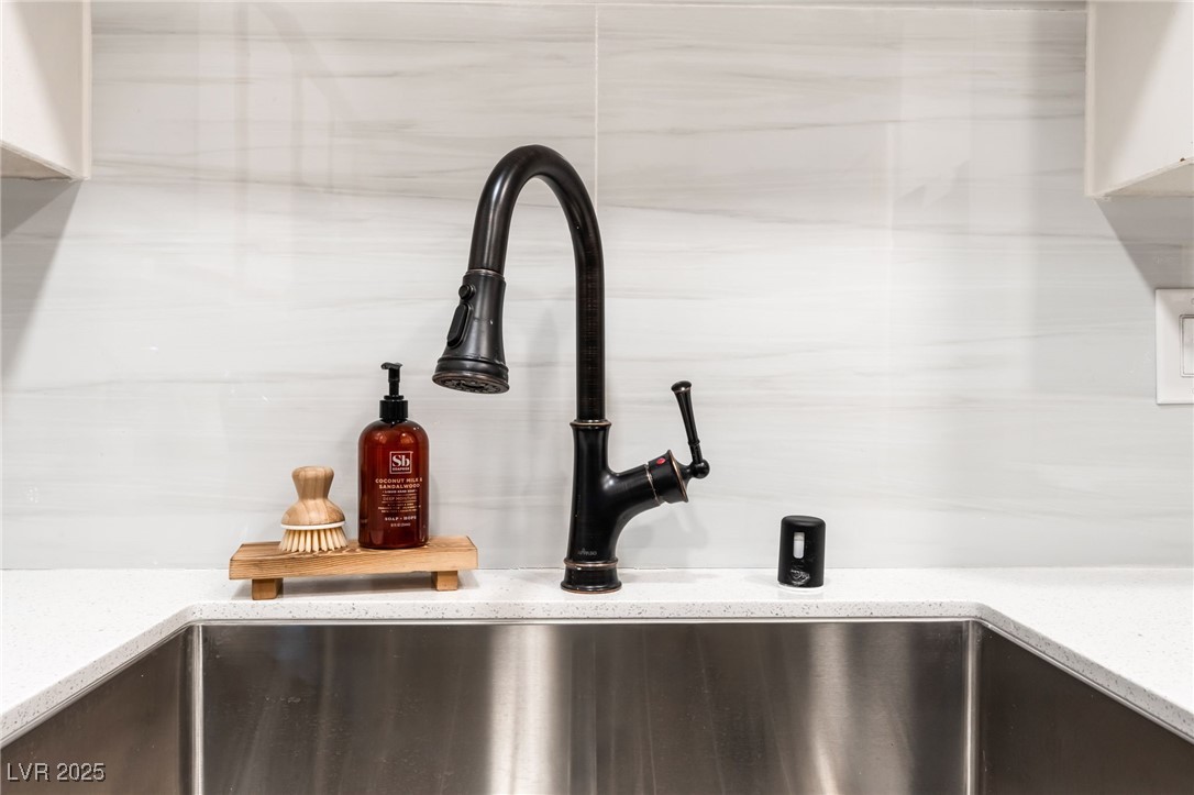 3151 North Soaring Gulls Drive, Unit 1188 Las Vegas, NV 89128 - Photo 13 of 43 Kitchen view of a sink and light stone counters