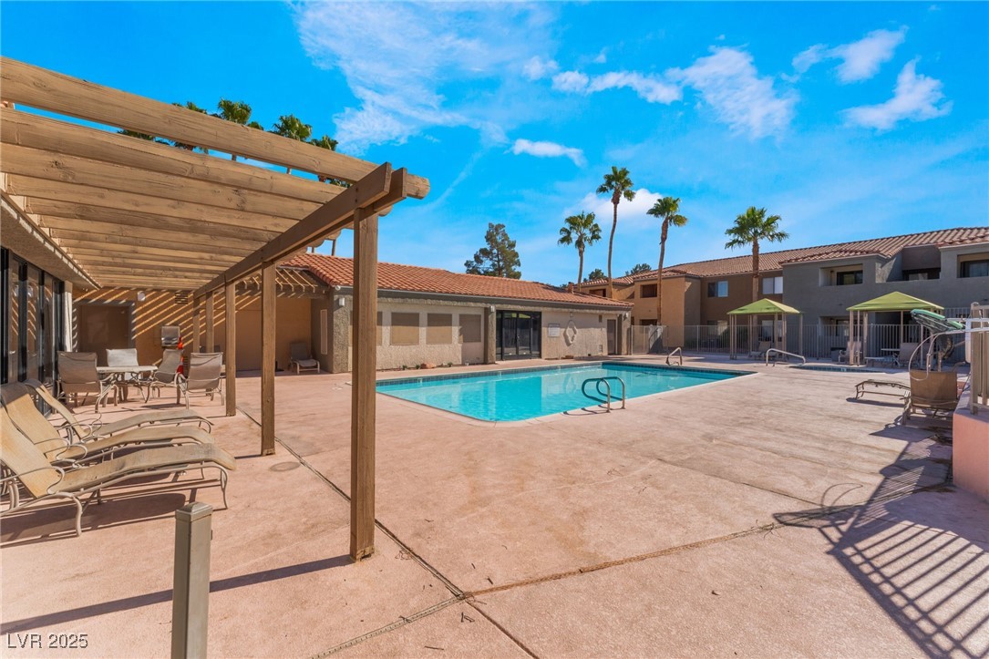 3151 North Soaring Gulls Drive, Unit 1188 Las Vegas, NV 89128 - Photo 33 of 43 Community pool with a patio and a pergola