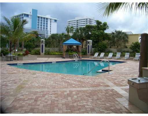 336 North Birch Road, Unit 5E Fort Lauderdale, FL 33304 - Photo 2 of 3 a view of a house with a yard and potted plants
