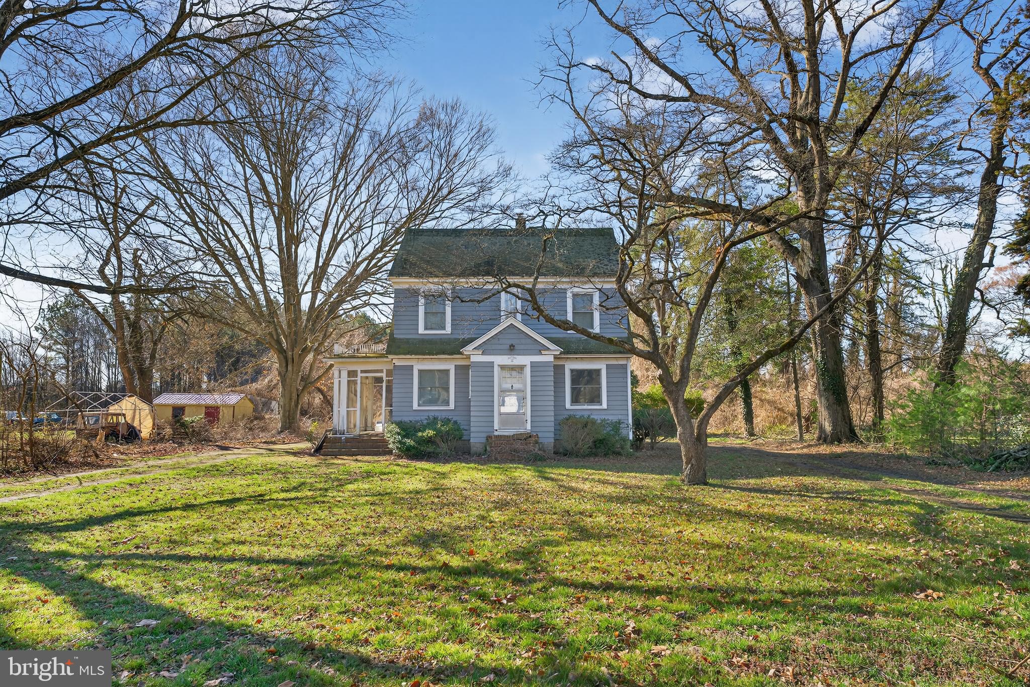 a front view of a house with a yard table and chairs