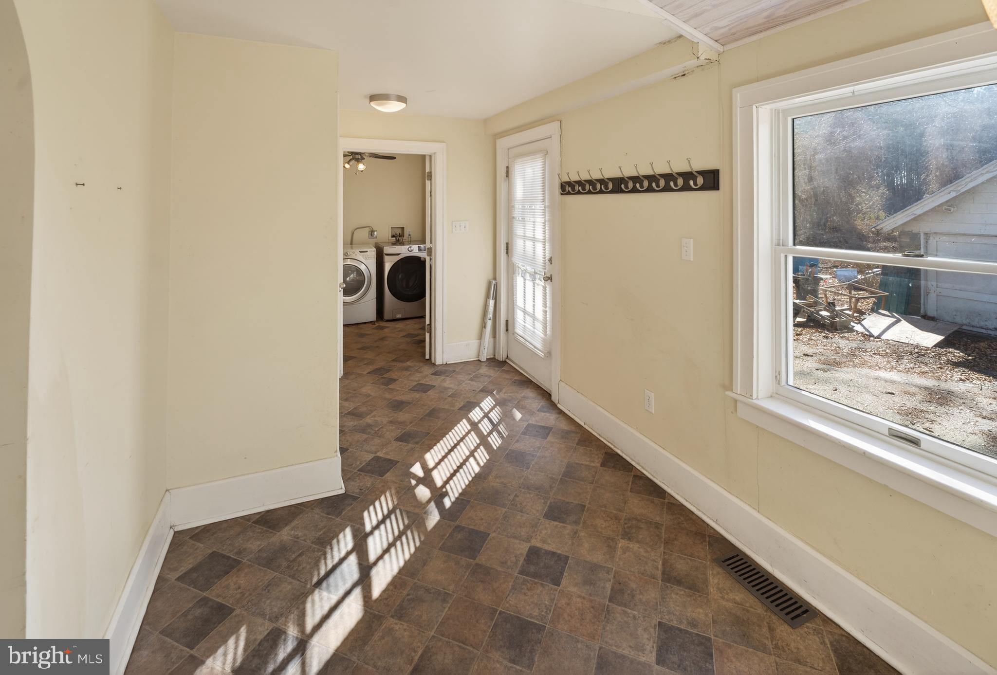 3202 Old Ocean City Road Salisbury, MD 21804 - Photo 11 of 29 a view of a hallway to a livingroom with wooden floor and a bookshelf