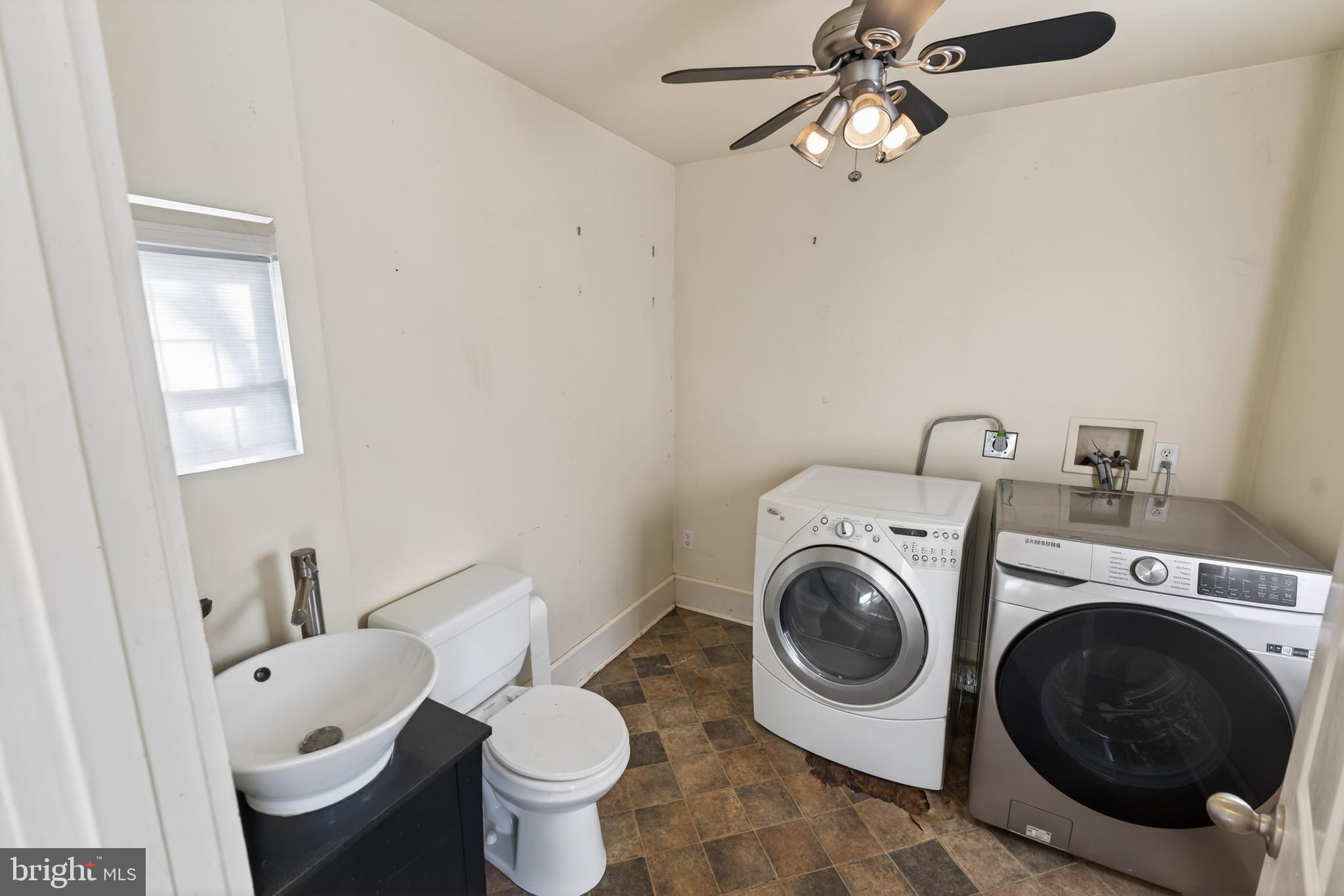 3202 Old Ocean City Road Salisbury, MD 21804 - Photo 14 of 29 a bathroom with a toilet and a washing machine