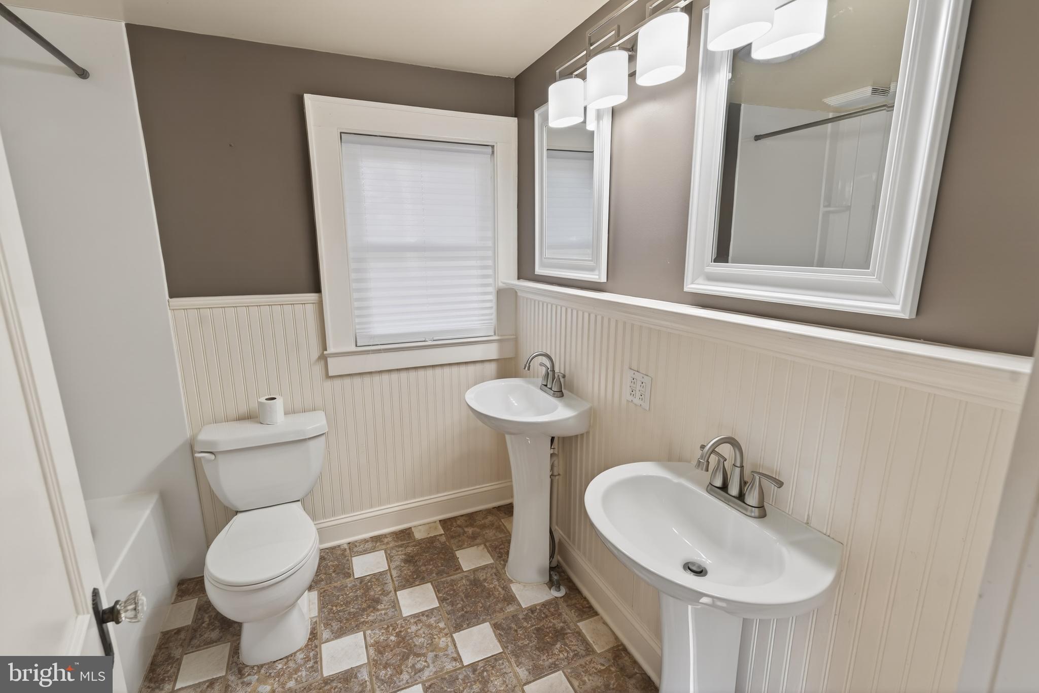 3202 Old Ocean City Road Salisbury, MD 21804 - Photo 18 of 29 a bathroom with a toilet sink and mirror