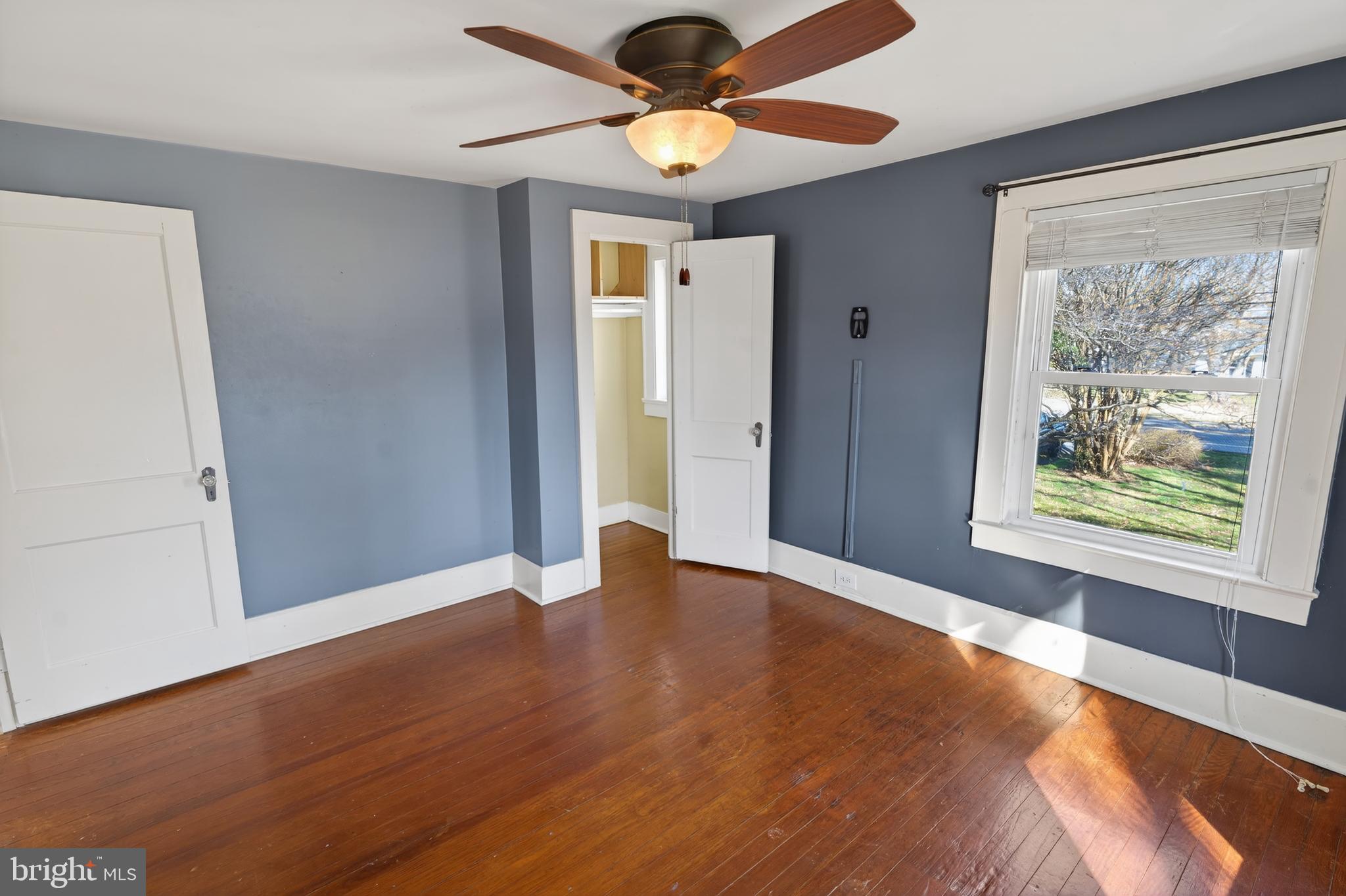 3202 Old Ocean City Road Salisbury, MD 21804 - Photo 20 of 29 a view of an empty room with window and chandelier fan